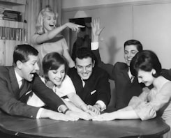 A group of friends laughing while playing a party game.