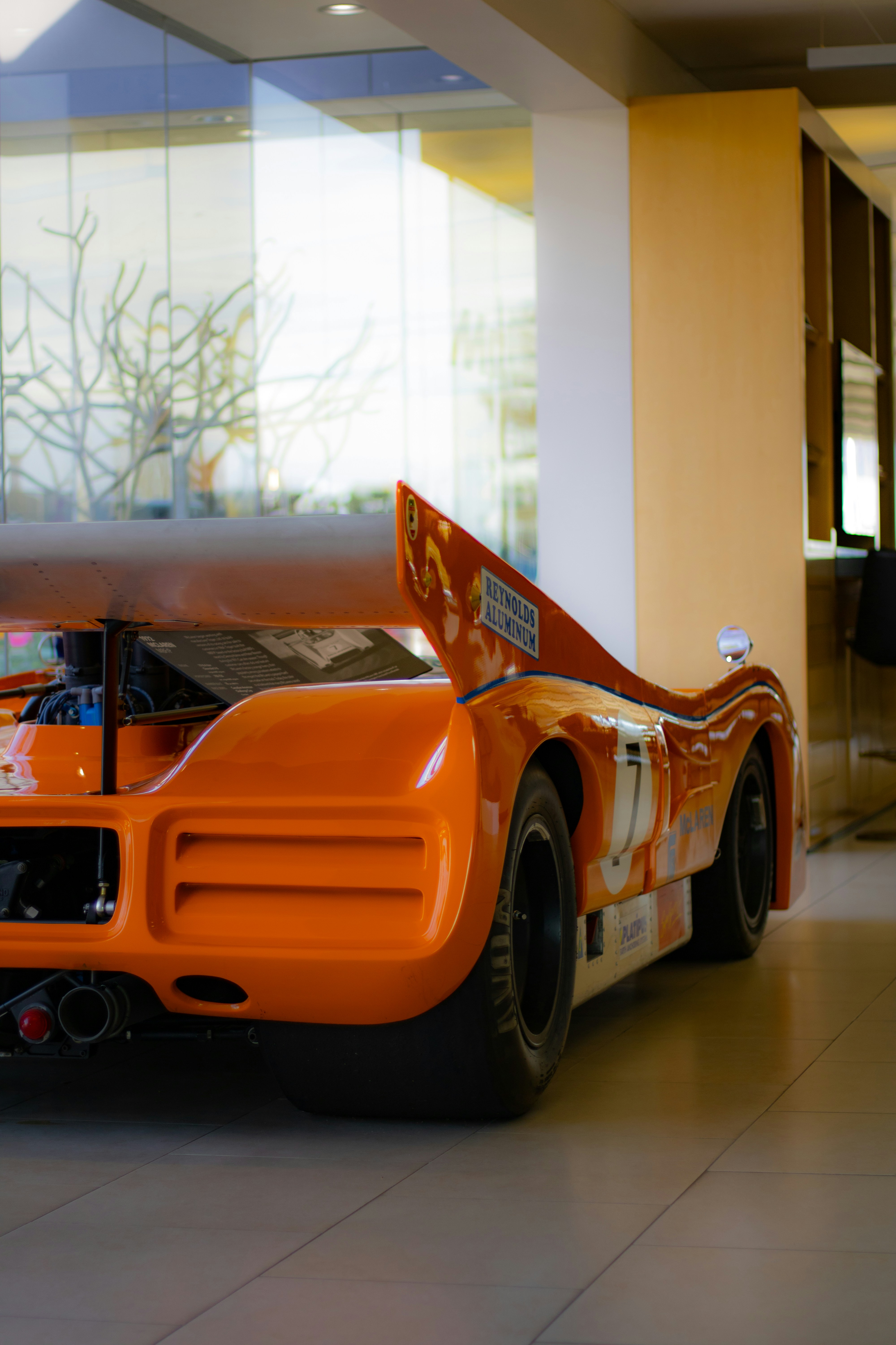 an orange race car parked inside of a building