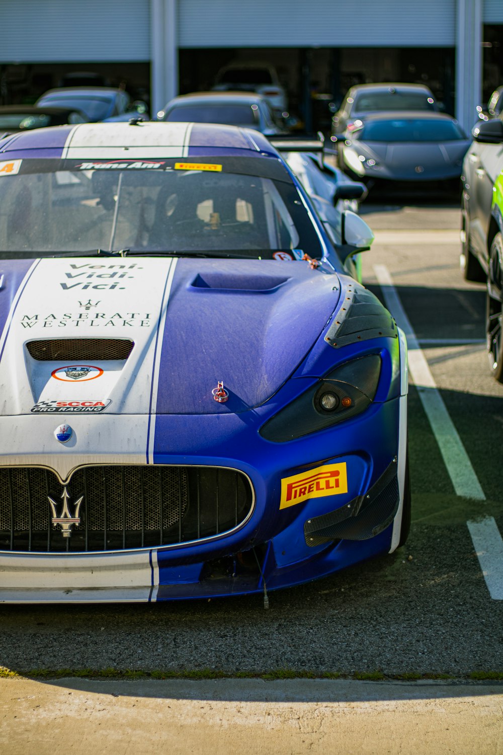 a blue and white sports car parked in a parking lot
