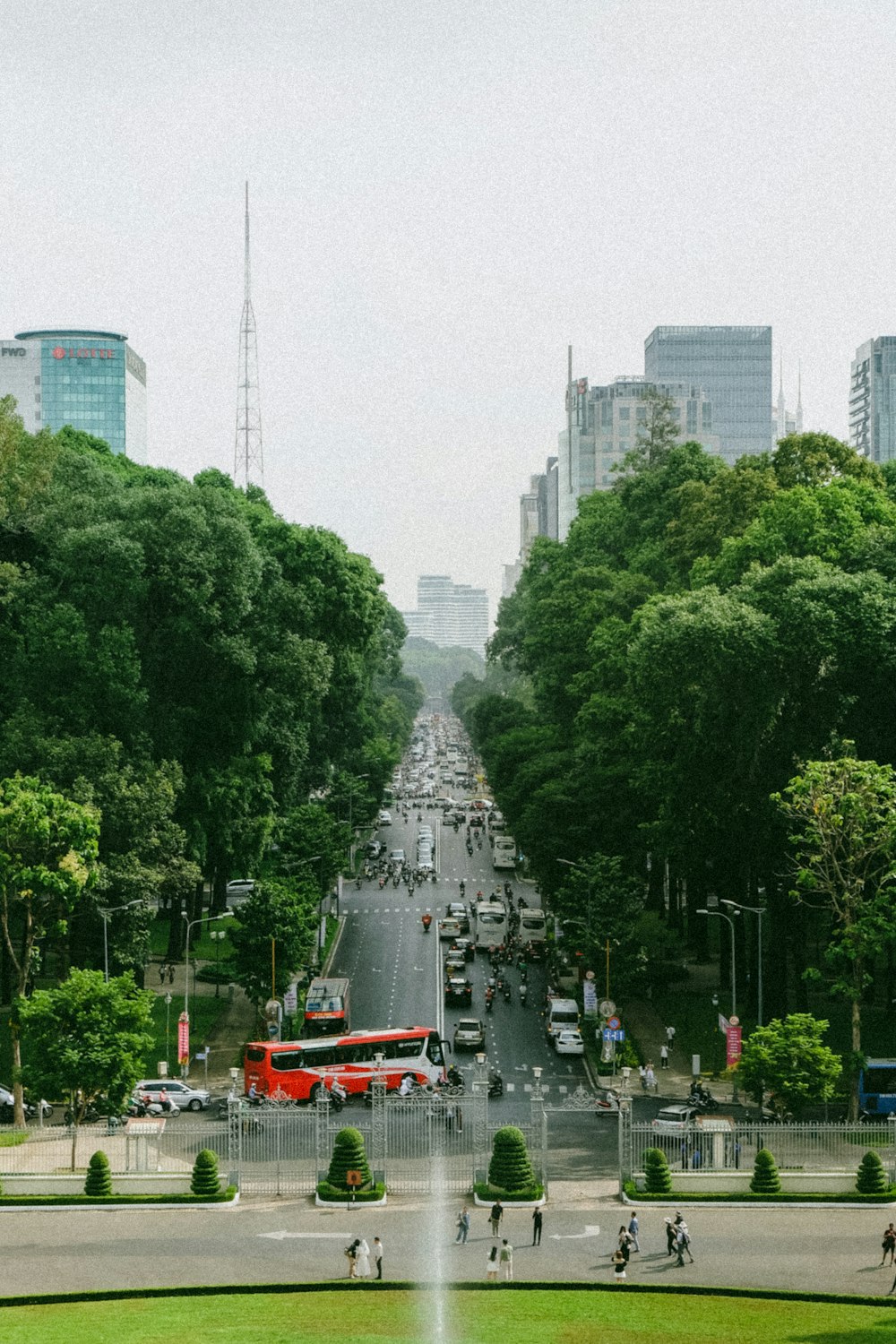 a city street filled with lots of traffic next to tall buildings