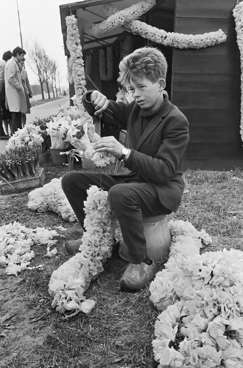 a woman is sitting on the ground with flowers