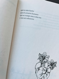 A page from a book featuring a short poem in Spanish about the resilience of the human heart. Below the poem, there is a minimalistic line drawing of a heart intertwined with blooming flowers.