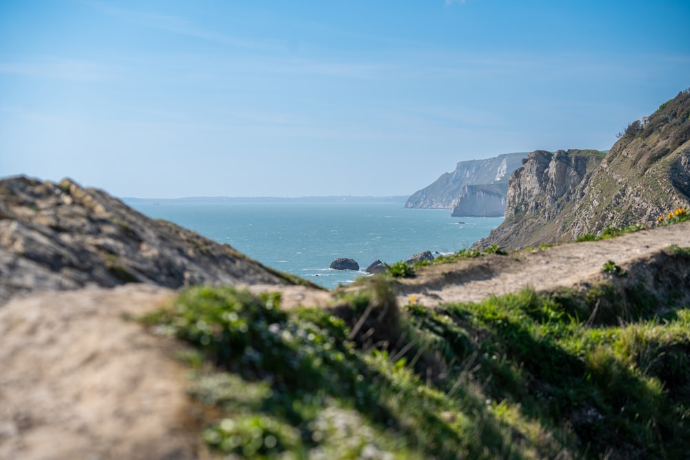 a view of the ocean from the top of a hill