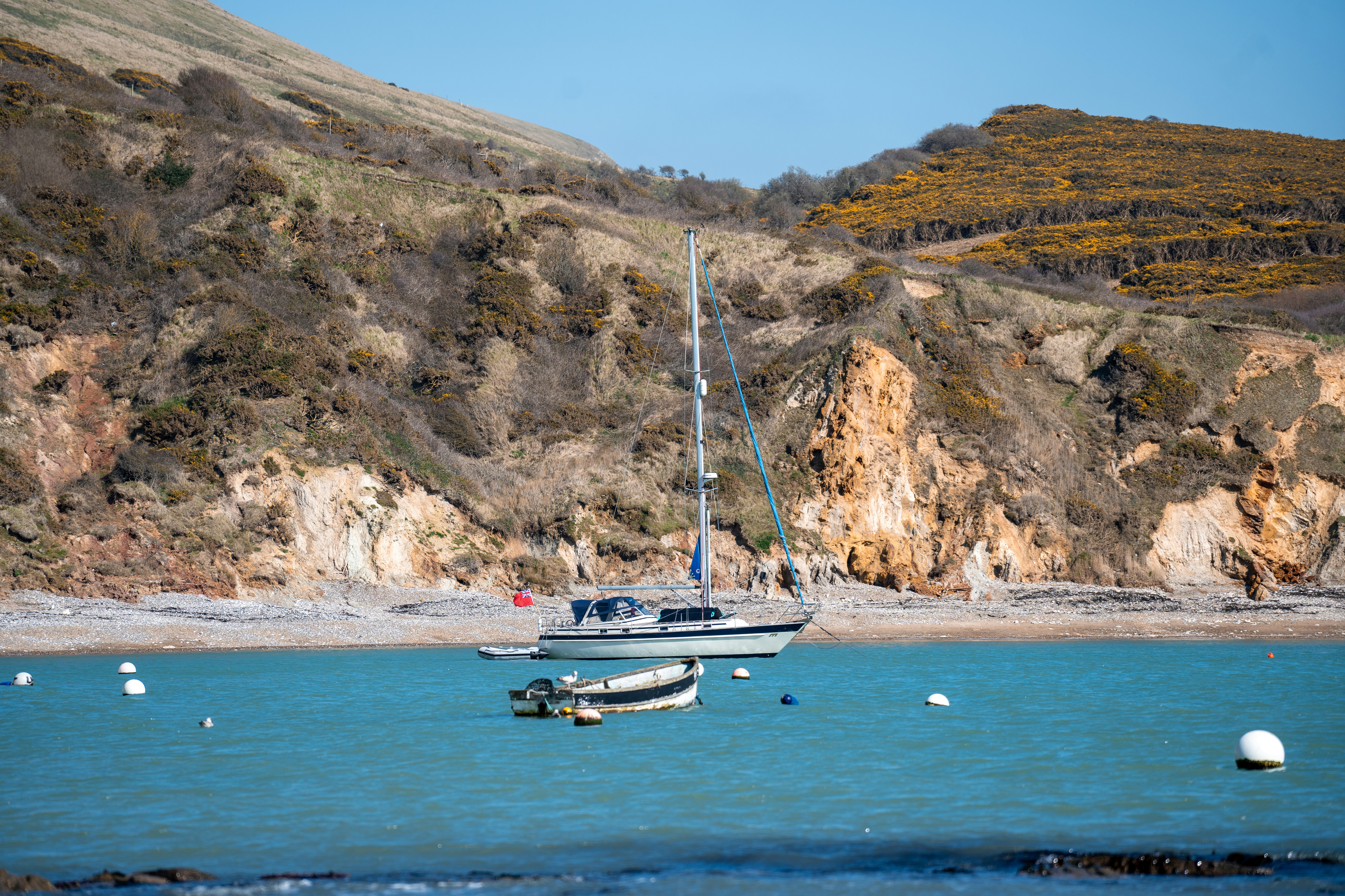a boat floating on top of a body of water, 