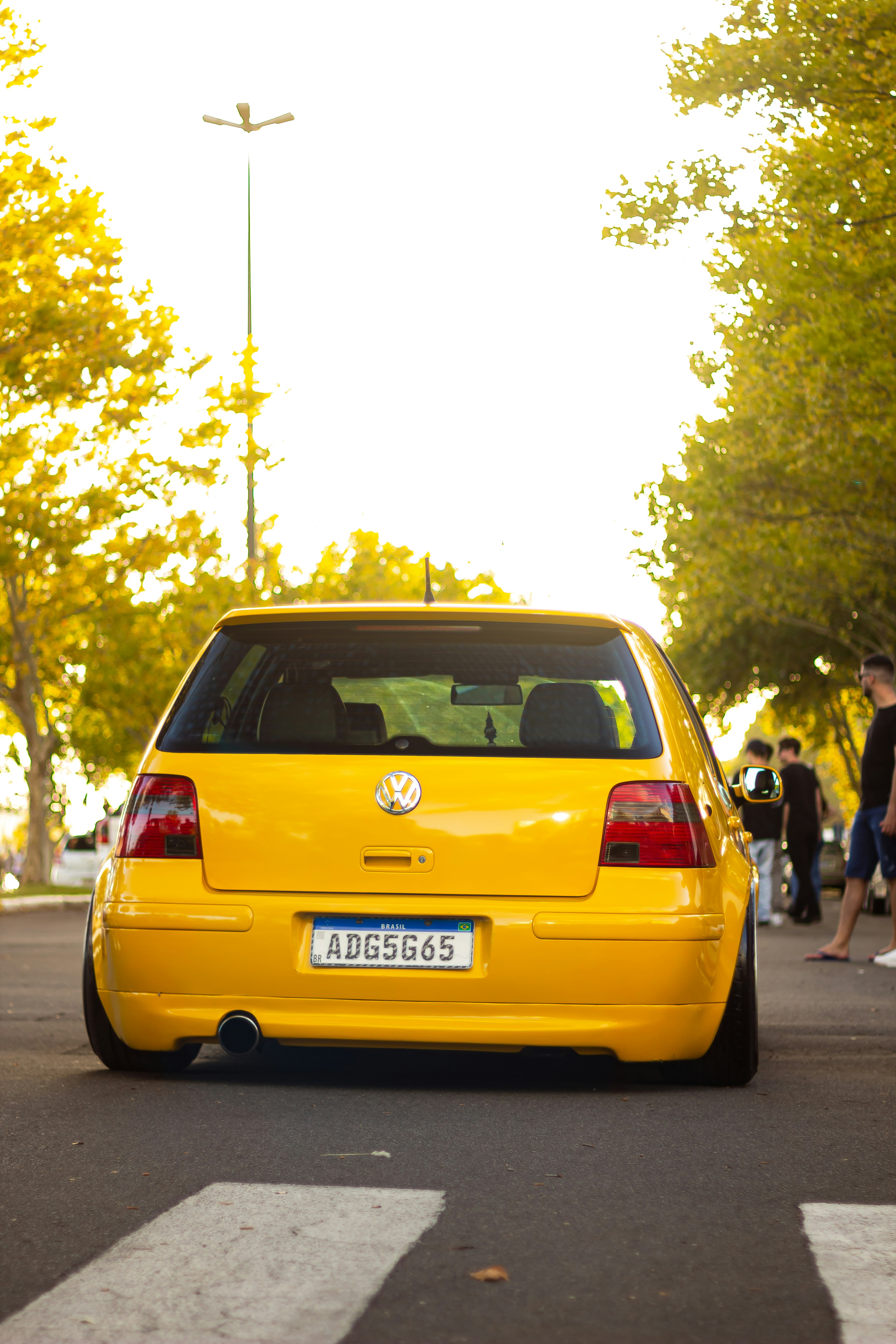 A yellow car parked on the side of the road photo – Free Brasil Image ...