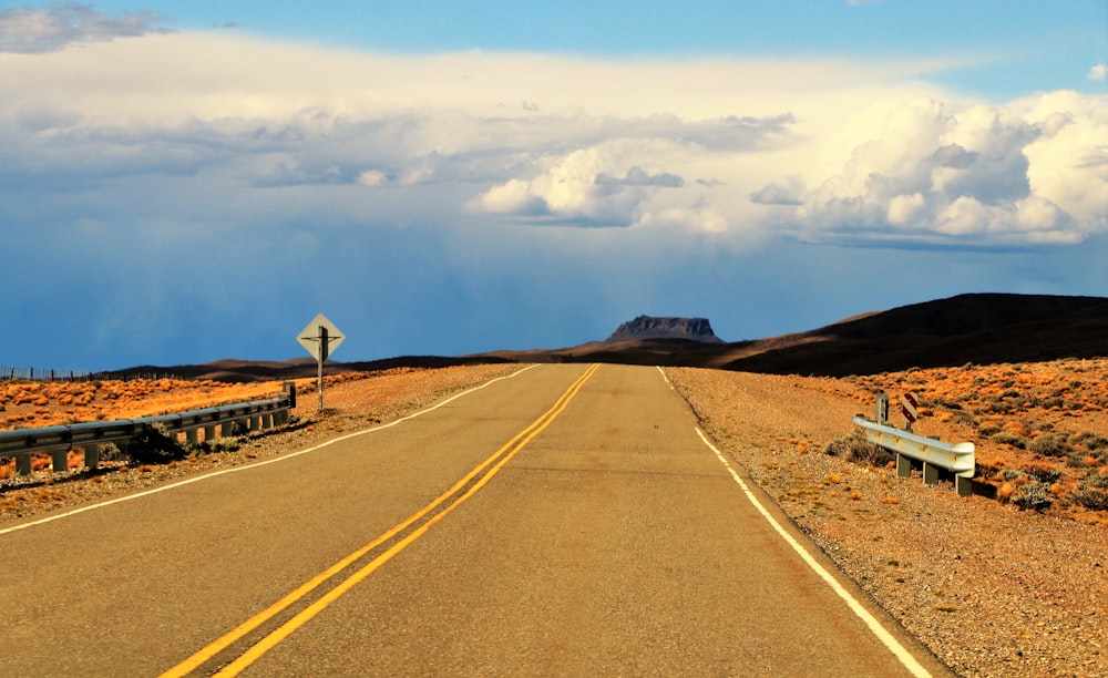 a road with a bench on the side of it