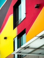 Wide shot of a commercial building with bold, colorful facade graphics designed by Cirio.
