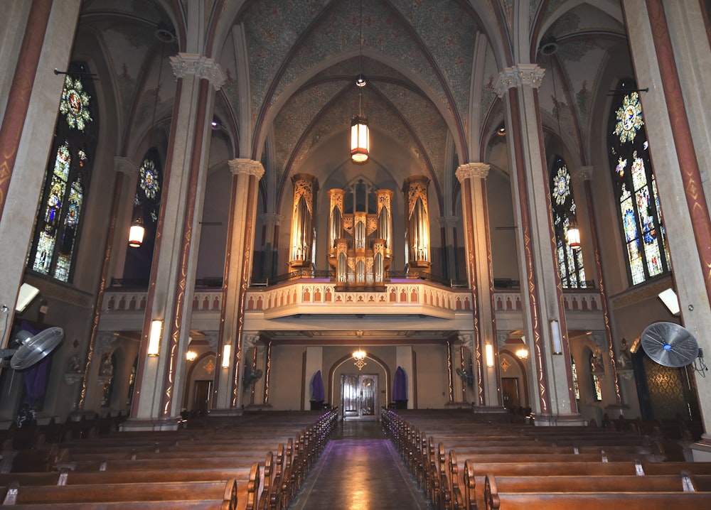 a church with pews and stained glass windows