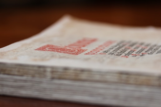 Close-up of stacked legal files with a courthouse blurred in the background, evoking a sense of unresolved justice.