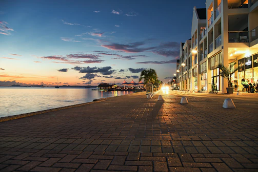 A vibrant waterfront development featuring retail shops and pedestrian promenades.