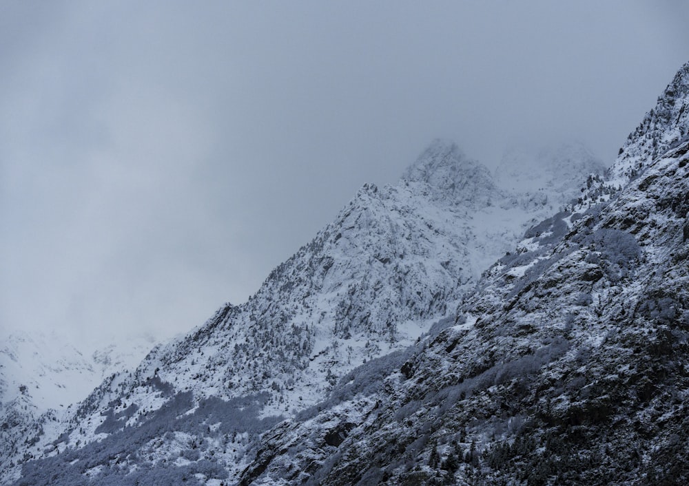 a mountain covered in snow with a sky background