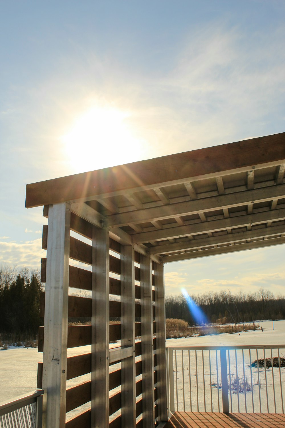 the sun is shining over a wooden structure