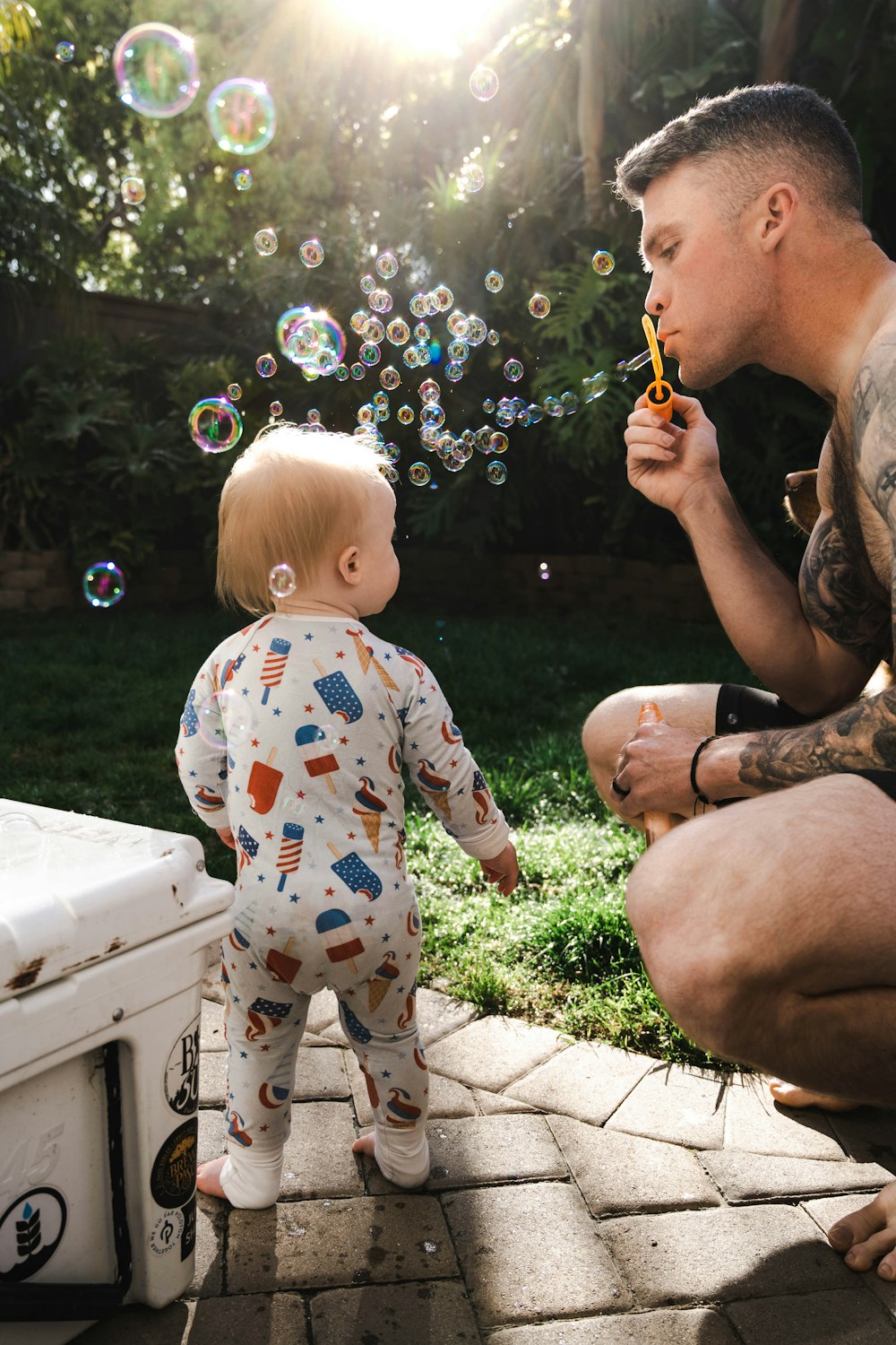 Ein Mann und ein Baby blasen Seifenblasen