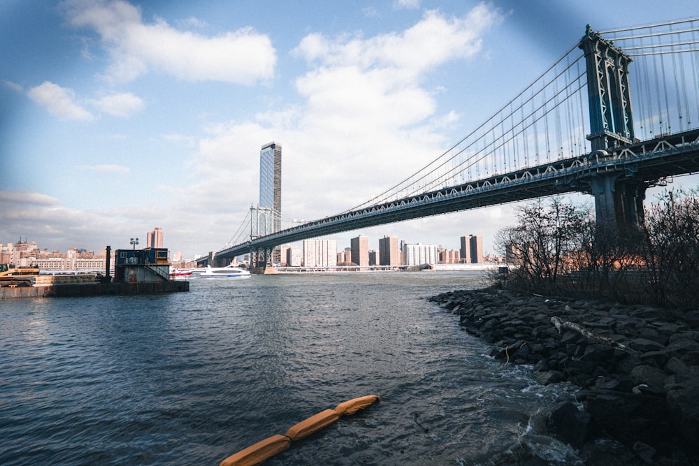 a body of water with a bridge in the background