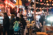 A private tour guide showing a group of Muslim travelers the lantern-lit streets of Hoi An at night.