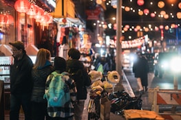 A private tour guide showing a group of Muslim travelers the lantern-lit streets of Hoi An at night.