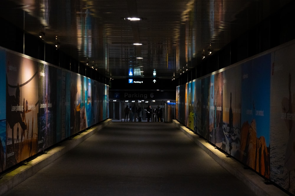 a long hallway with a lot of paintings on the walls