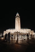 The illuminated Masjid Nabawi at night with worshippers