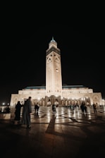 The illuminated Masjid Nabawi at night with worshippers