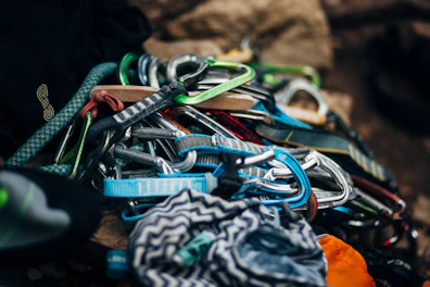 A selection of colorful climbing harnesses hanging neatly in the Thrillout store.