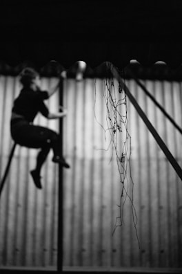 Close-up of hands gripping the pole, showing determination and effort