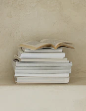 a stack of books sitting on top of a table