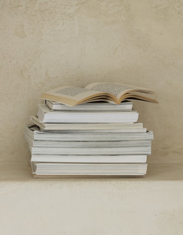 a stack of books sitting on top of a table