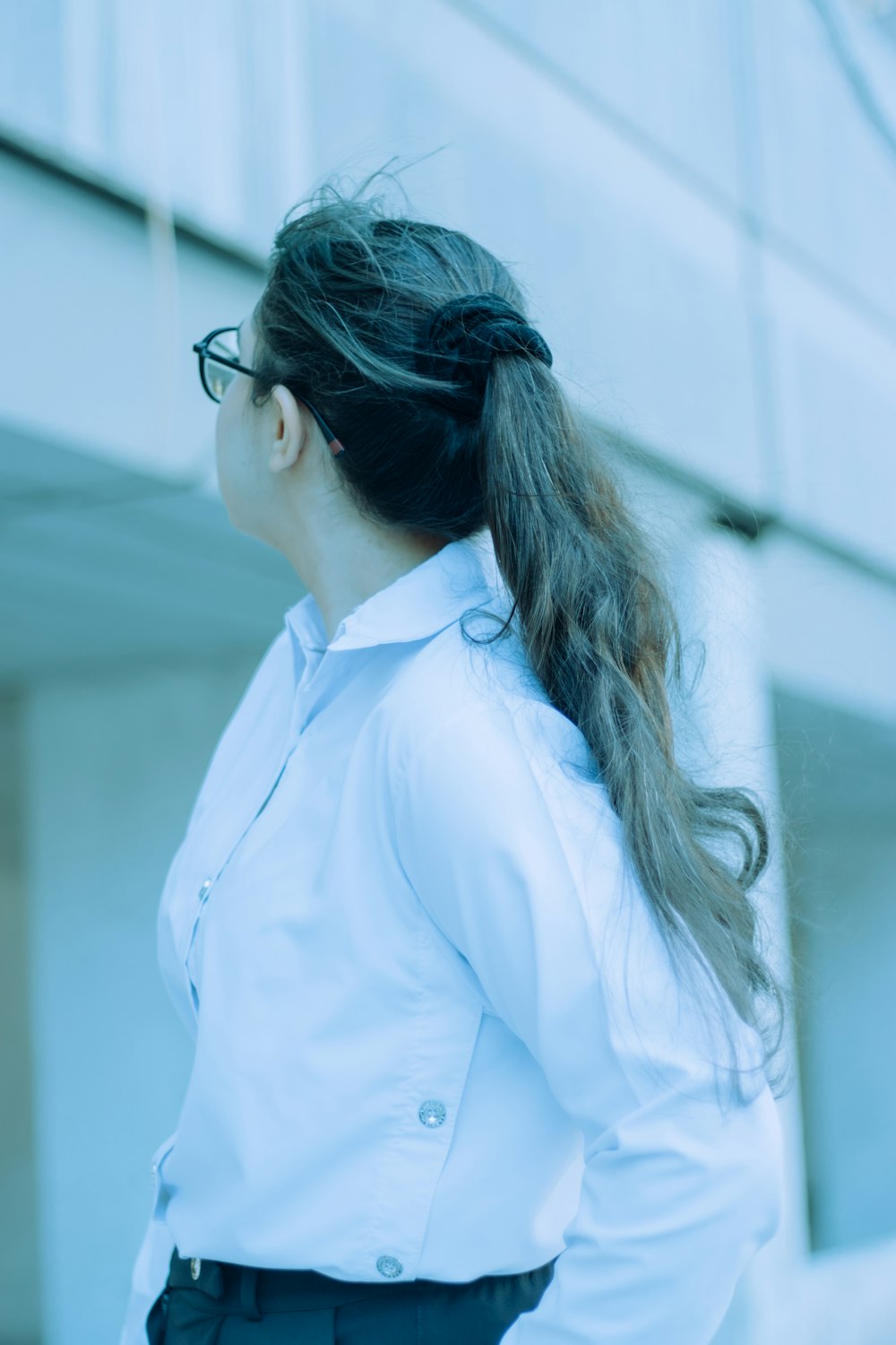 a woman in a white shirt and black pants