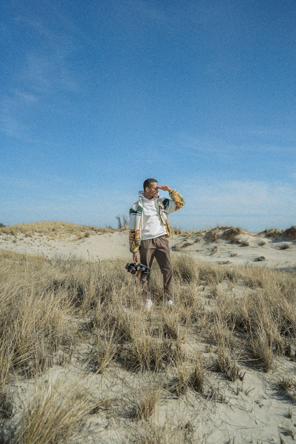 a man standing on top of a sandy beach