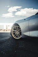 Close-up of a semi-truck's polished chrome wheels on asphalt.