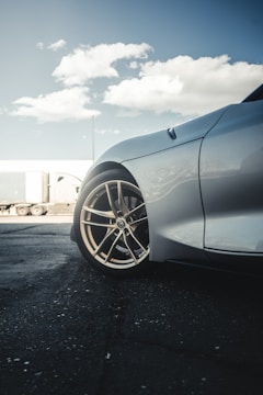 Close-up of a trailer's wheels on a highway during a sunny day