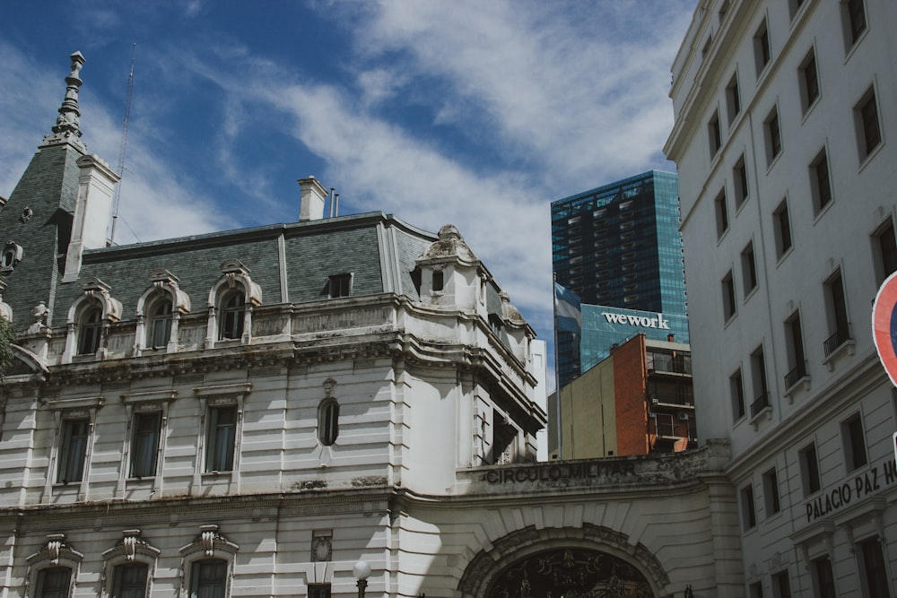 a large white building with a clock on it's side