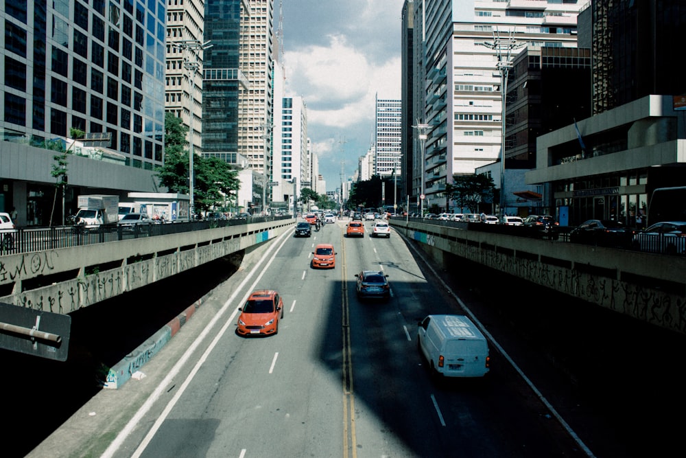 a city street filled with traffic next to tall buildings