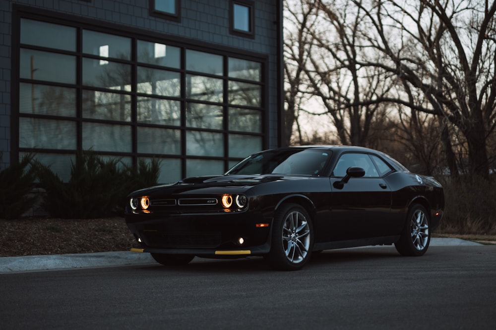 a black car parked in front of a building