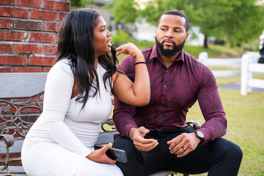 a man and a woman sitting on a bench