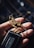 A hand is holding a set of keys. The focus is on a detailed metal keychain shaped like a mechanical insect or grasshopper. The keychain is intricately designed with metallic accents. The keys attached include a modern car key with a sleek black design.