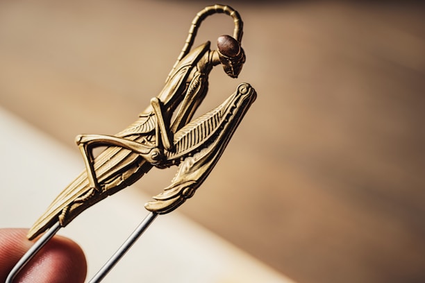 A close-up of a delicate sculpture depicting an intricate insect design.