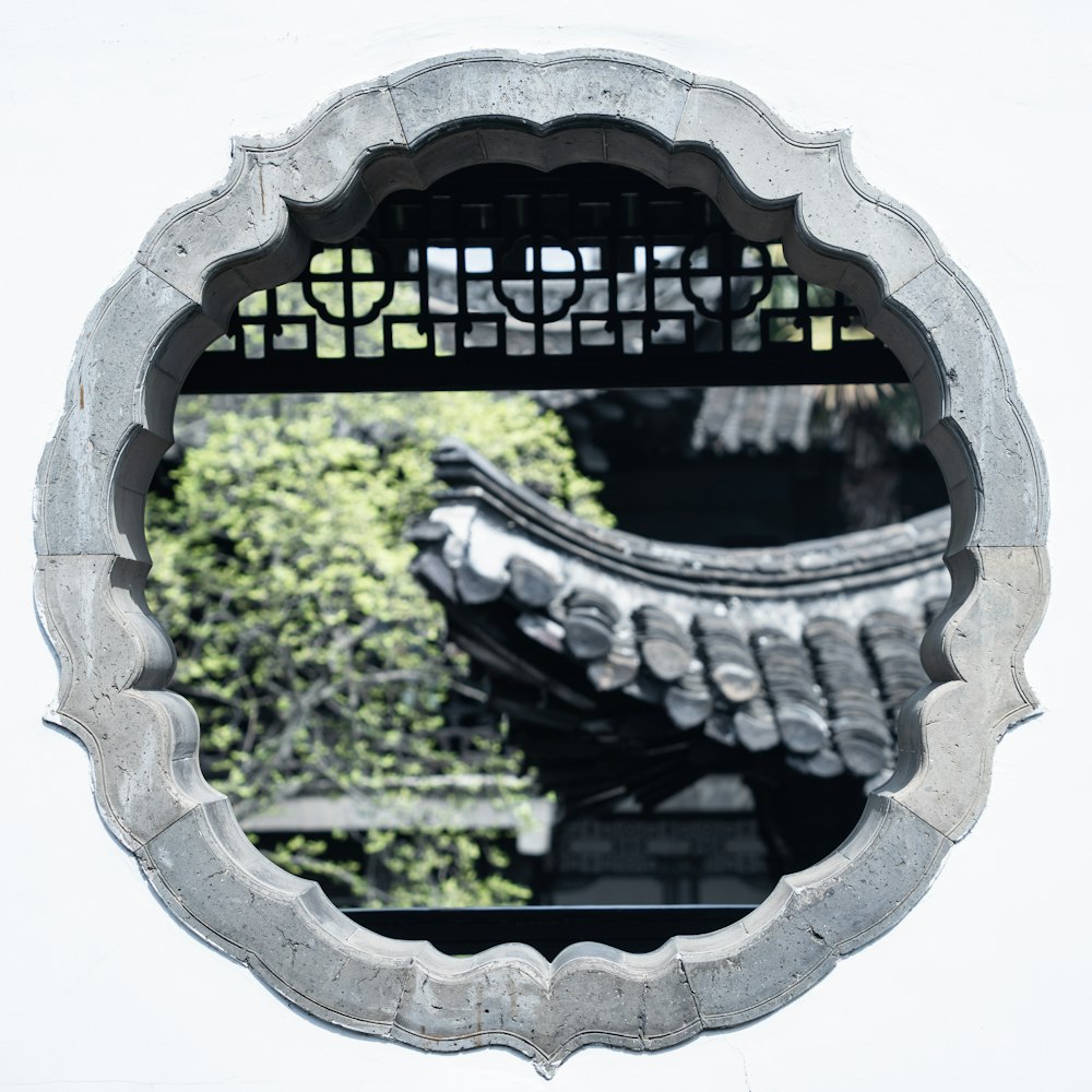 a circular mirror with a reflection of a building