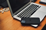 a laptop computer sitting on top of a wooden desk