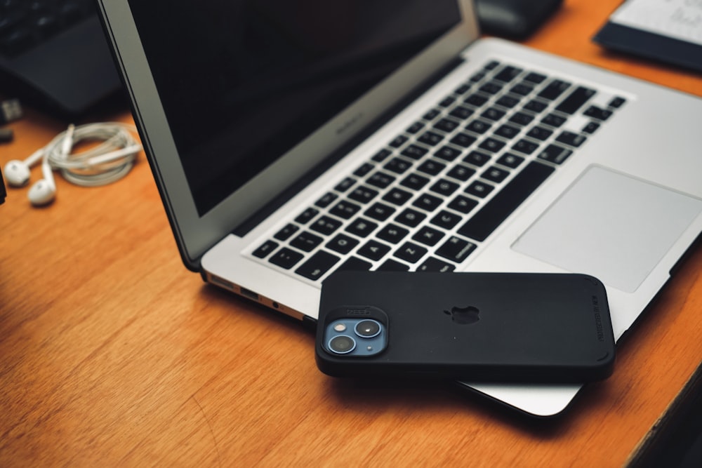 a laptop computer sitting on top of a wooden desk