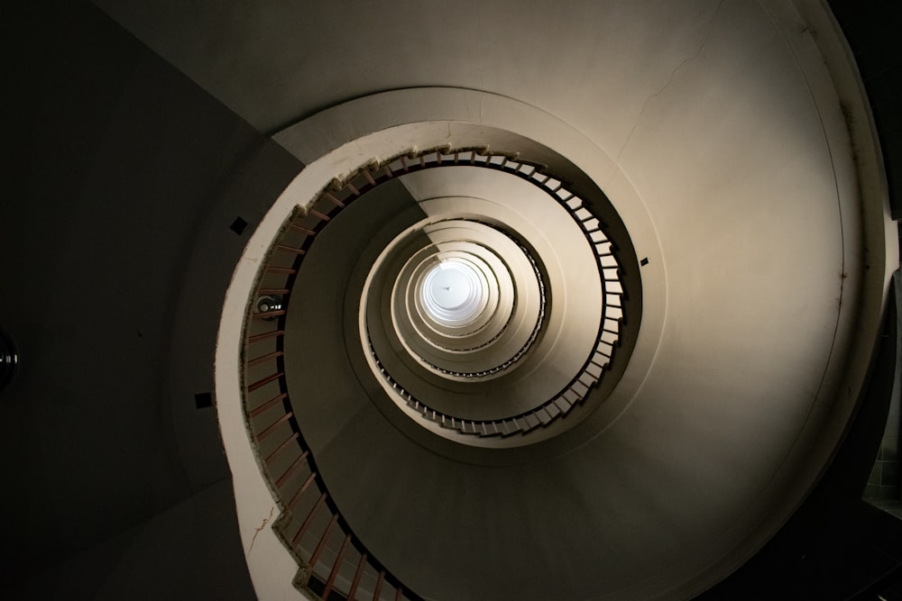 a spiral staircase with a light at the top