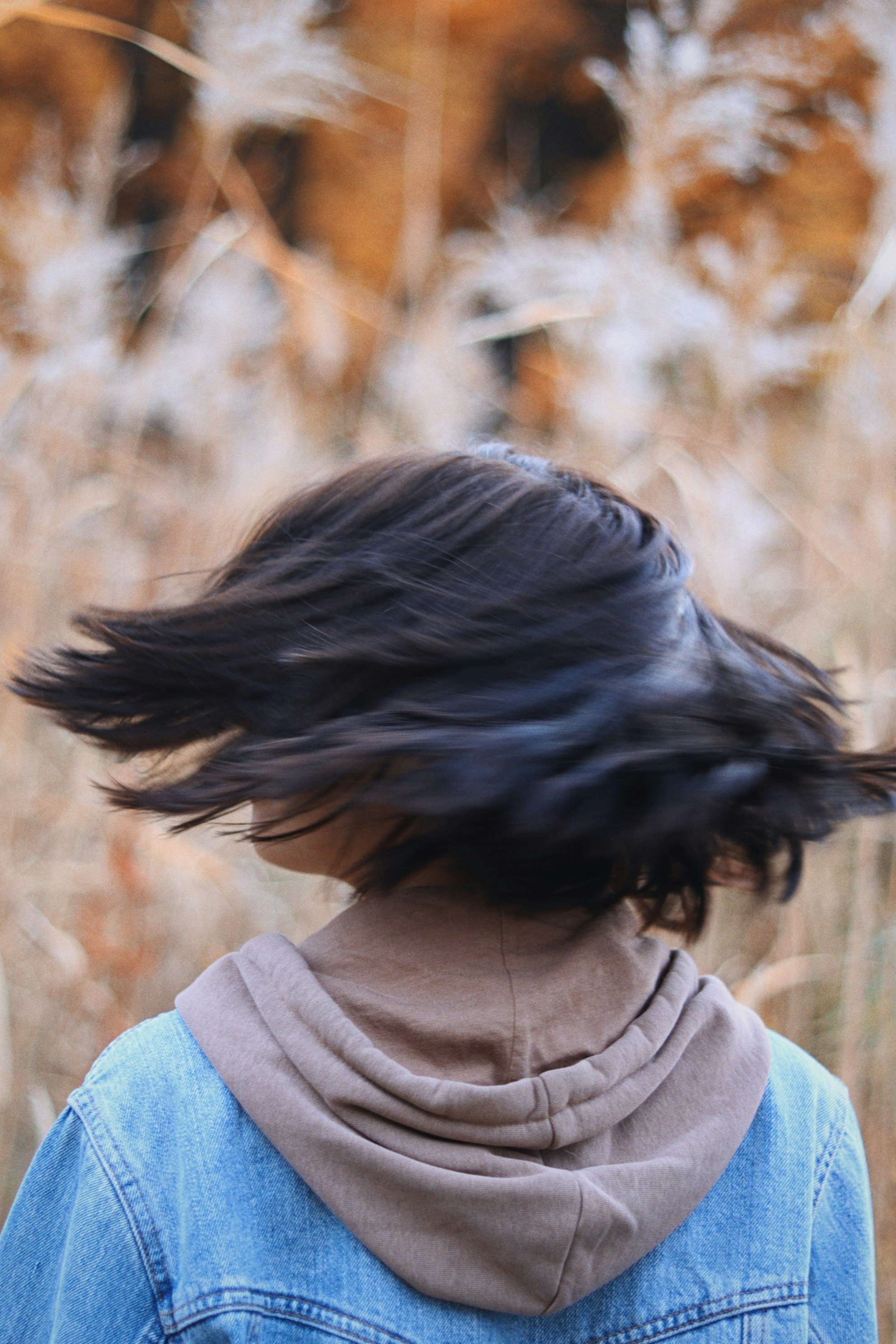 a woman with her hair blowing in the wind