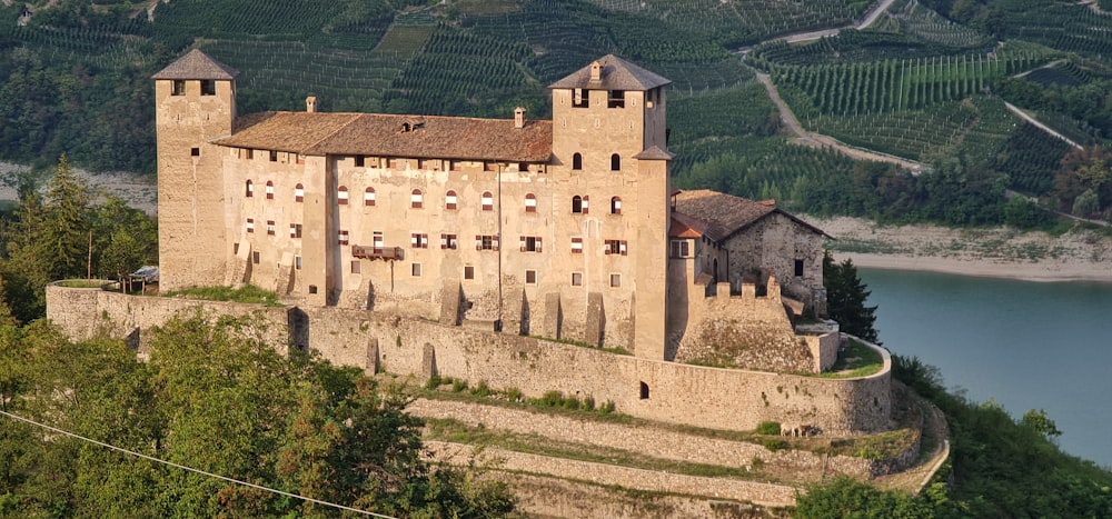 a castle on a hill overlooking a river