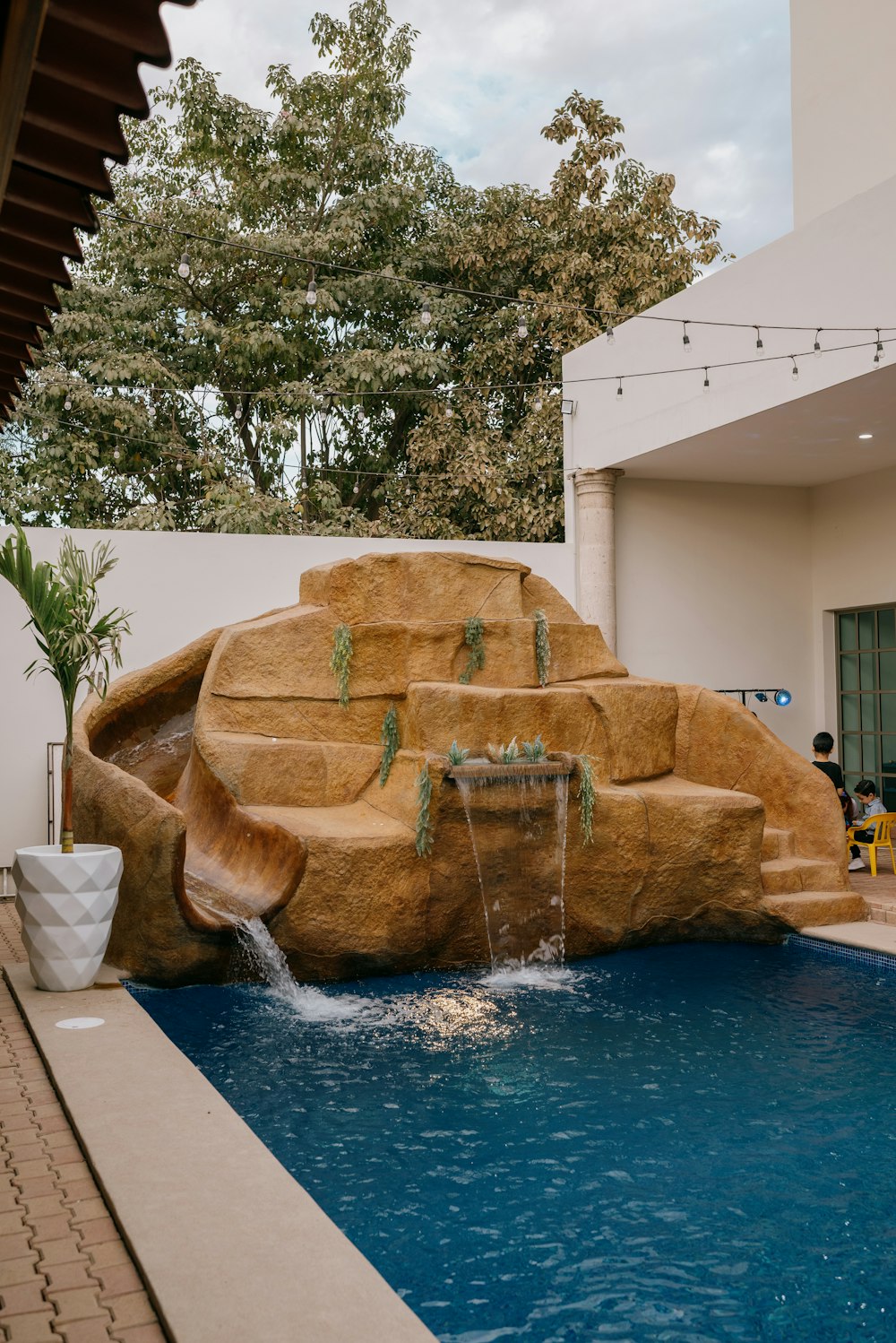 a pool with a waterfall in the middle of it