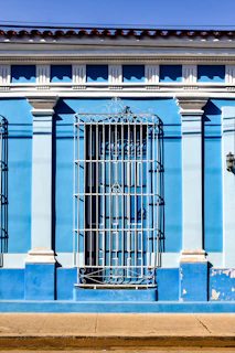 Elegant exterior facade of a restored colonial house with vibrant colors and detailed moldings