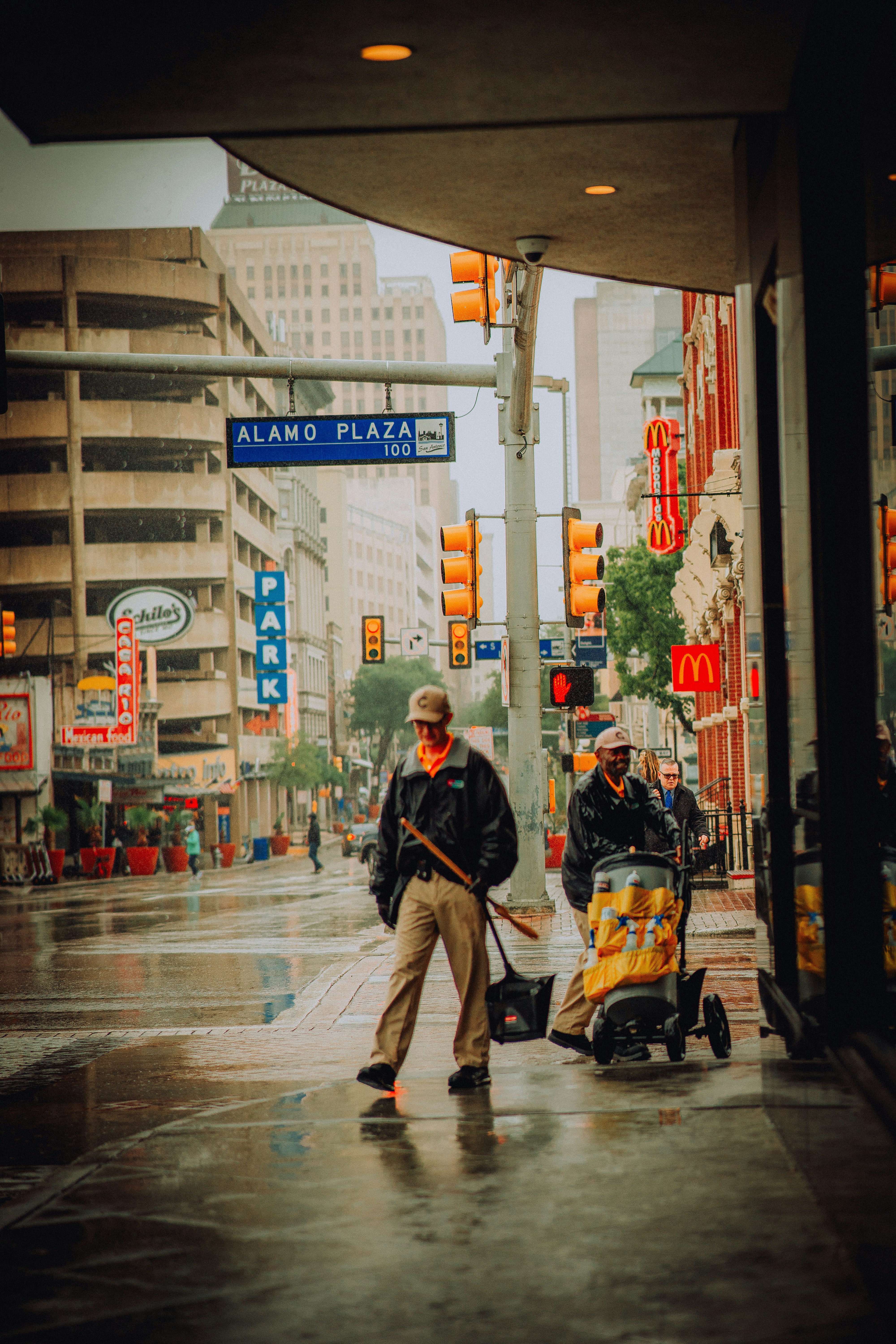 a man sweeping the street with a broom