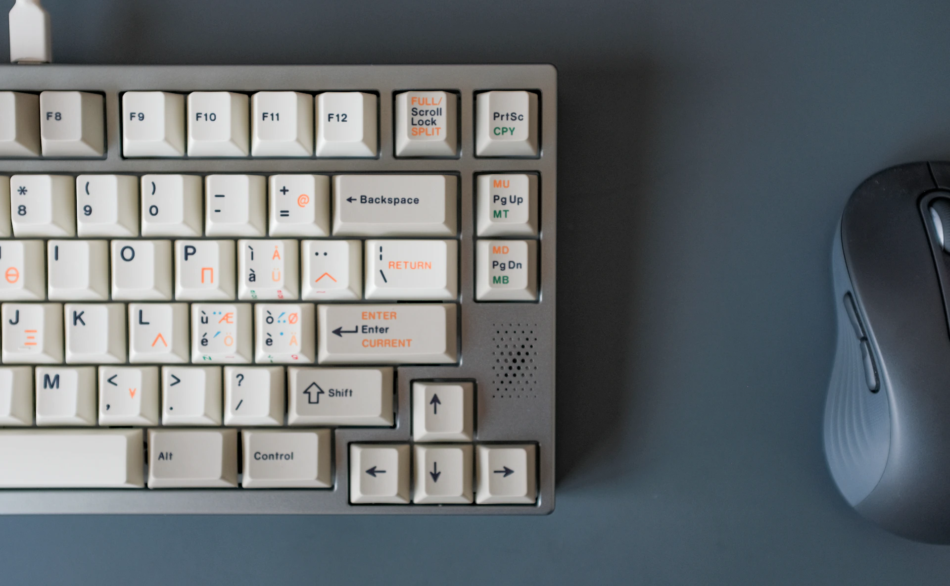 a computer keyboard and a mouse on a table