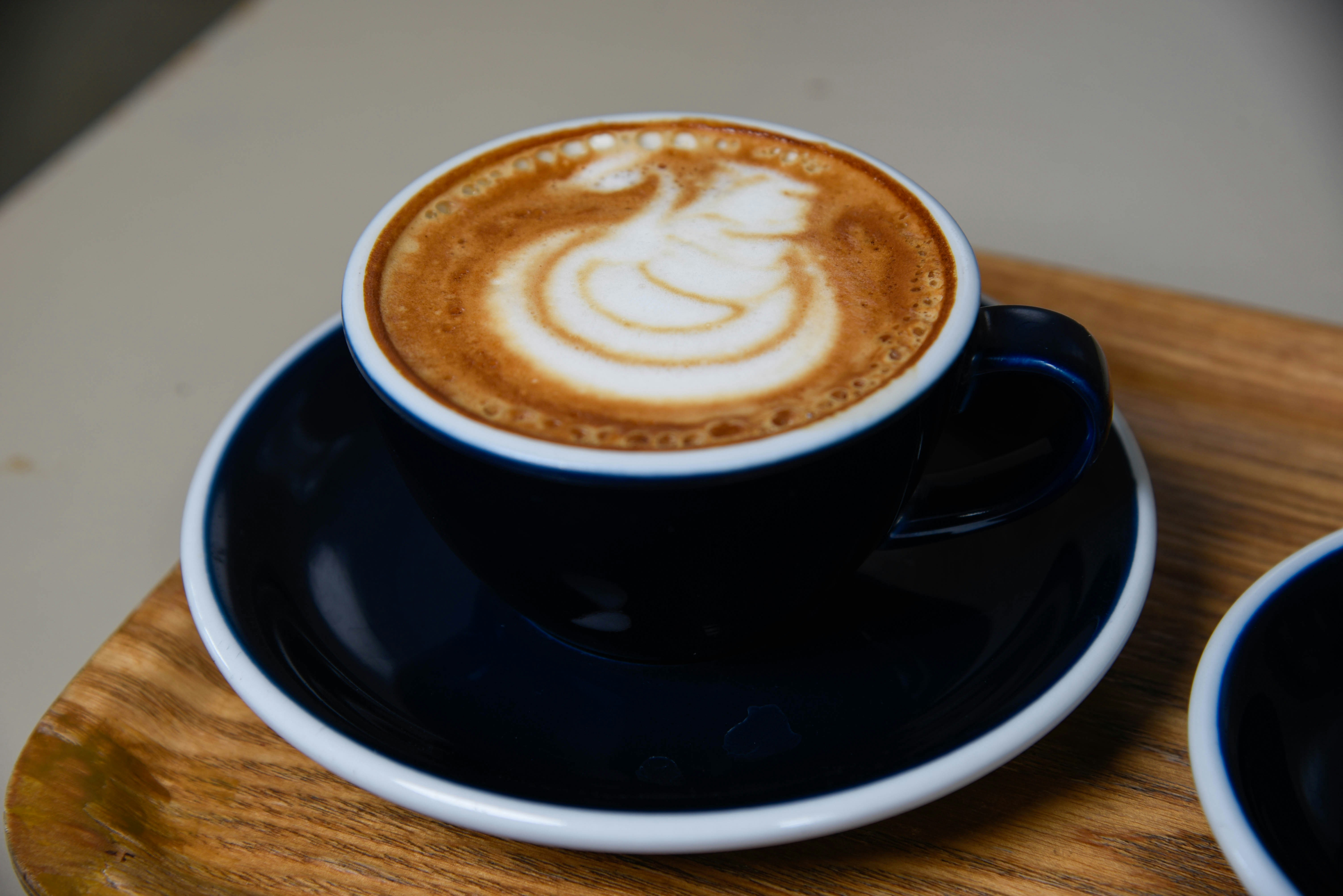 Cappuccino on wooden saucer