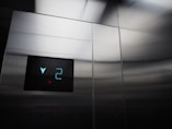 a close up of a metal wall with a clock