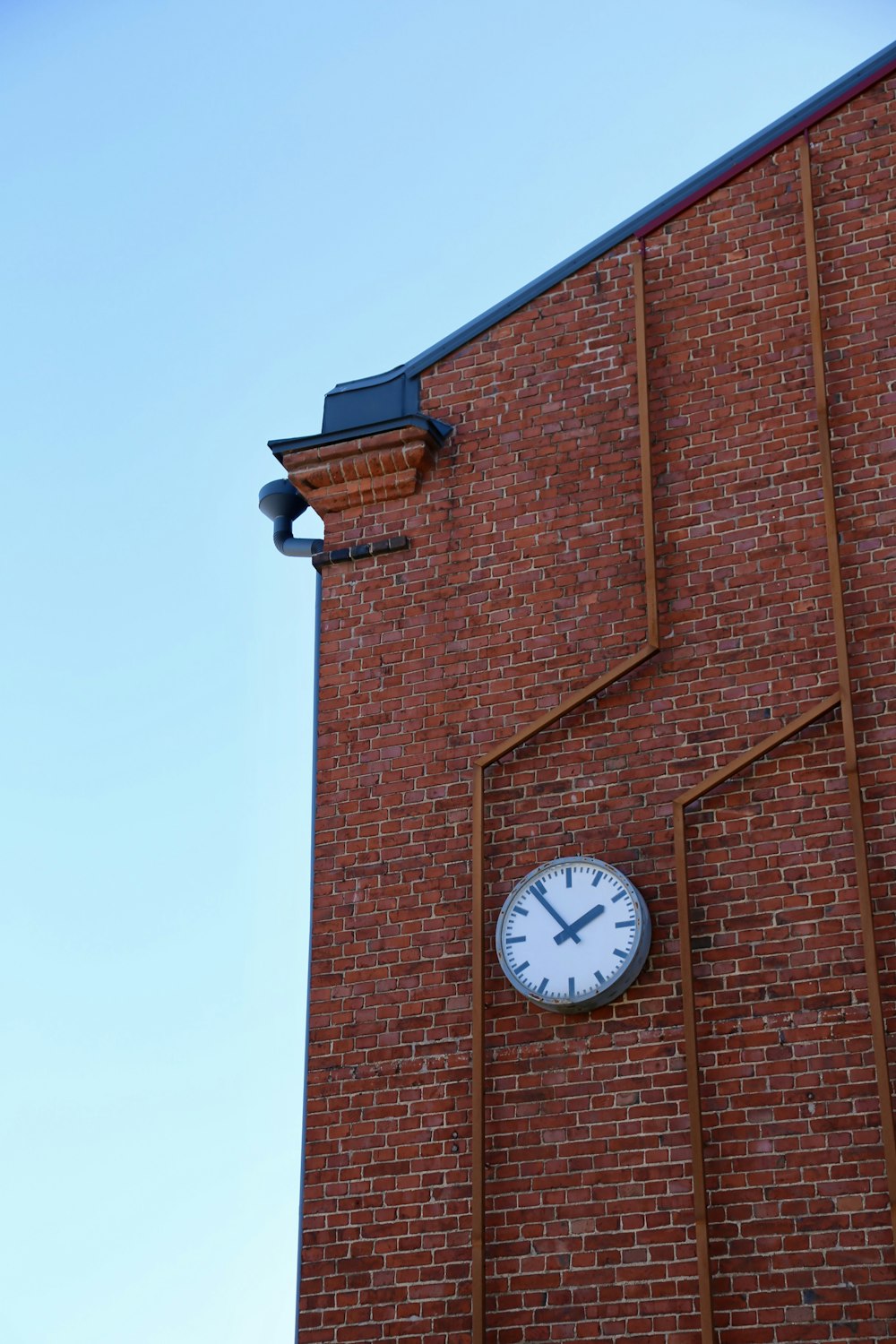 a clock on the side of a brick building